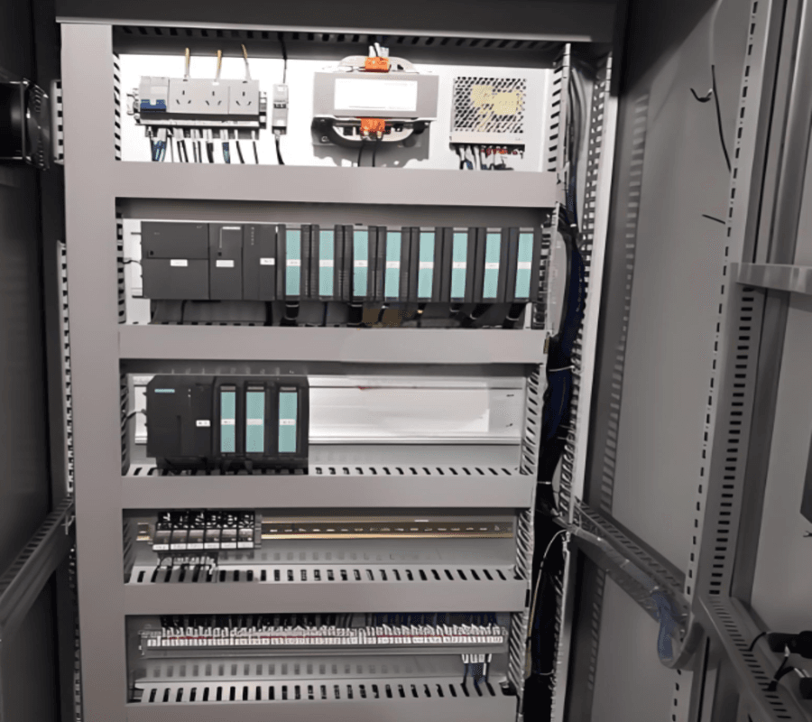 Custom electrical control cabinet with PLC modules and internal wiring